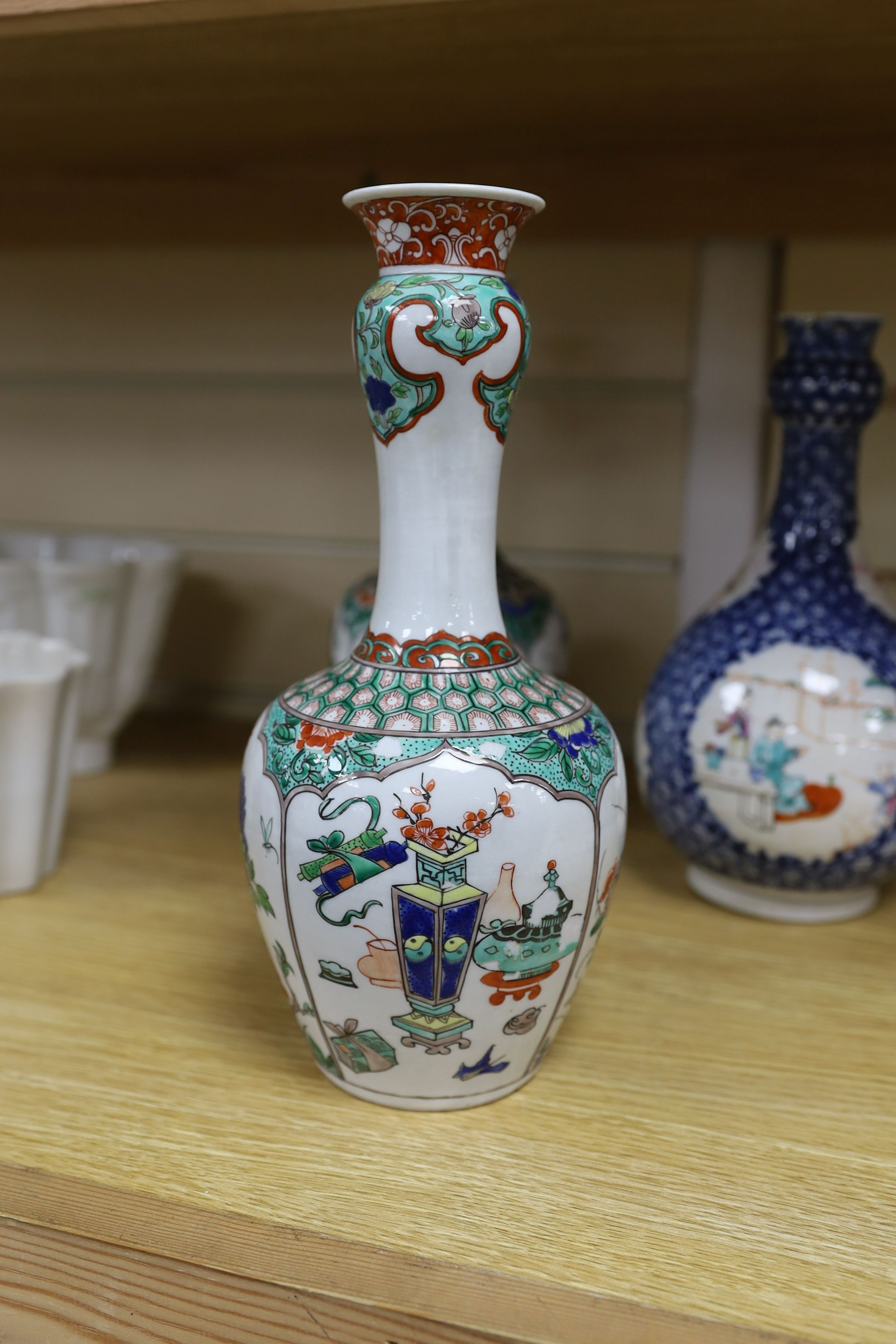 A pair Samson of Paris vases in the Chinese famille verte style and a Chinese Qianlong famille rose garlic neck vase with blue panelling motif, tallest 26cm
